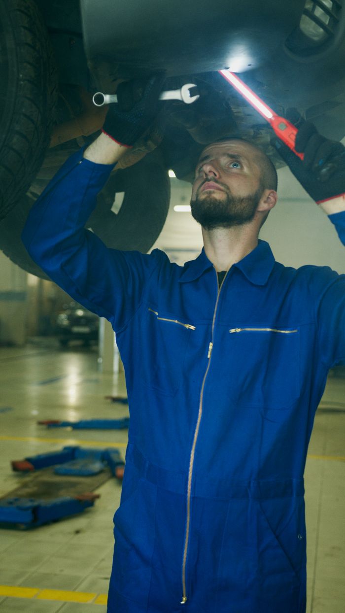 Collision repair technician working on a vehicle